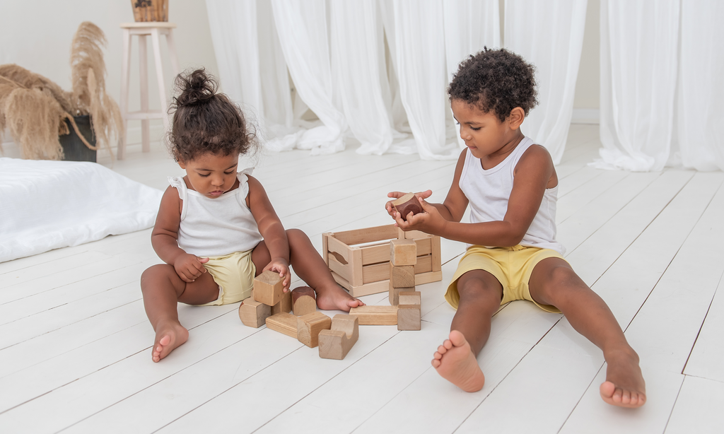 little girl and little boy playing with simple wooden blocks | ade + ayo