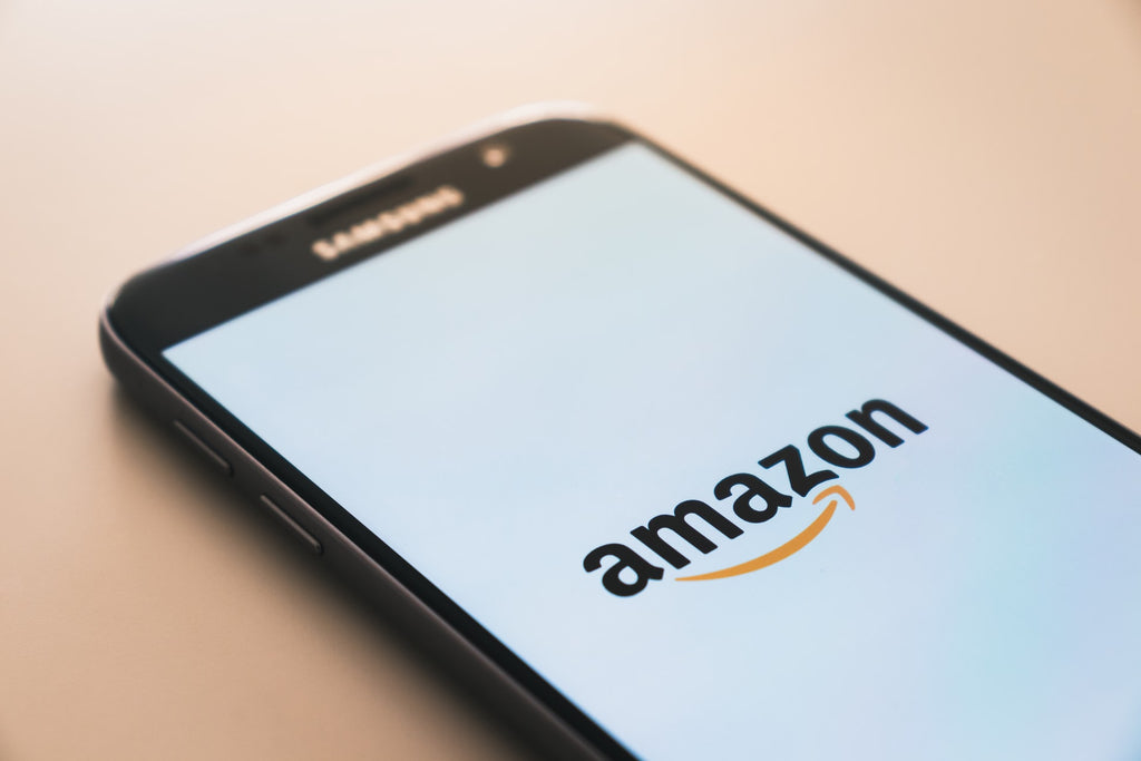 Phone with Amazon Logo | 5 Easy Ways to Shop Sustainably on Amazon